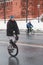 Cyclist rides on special bike along the Kremlin walls in winter.