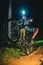 Cyclist rides up a dirt trail at night in Flower Mount, United States