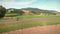 Cyclist riding bicycle on asphalt road with mountain hills in background. Road cycling. Woman cycling on bike along epic nature la