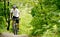 Cyclist Riding the Bike on the Trail in the Forest