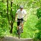 Cyclist Riding the Bike on the Trail in the Forest