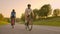 Cyclist Riding On Road Bike Rear View.Cycling Men Pedalling Road Bicycle On City Park.Tracking Shot Of Cyclist Rides On