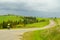 Cyclist riding on the road. Green Hills. Winding road. A cyclist rides to the goal