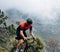 Cyclist on road bike riding in wild terrain