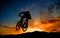 Cyclist silhouetted at sunset