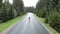 Cyclist sprinting out of saddle on bicycle. Woman taking part in bike race competition, hard pedaling on bike. Woman intensive spi