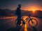 Cyclist stands confidently beside his bicycle on the tranquil road, basking in the golden glow of a beautiful evening sunset