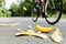 cyclist swerving to avoid banana peel on road