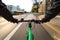 A cyclist and a tram ride down a street - First-person view of cyclist