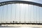 Cyclist and walker in silhouette on Humber Bay Arch Bridge