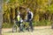 Cyclists with bikes in autumn park