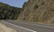 Cyclists biking in a curved empty spanish road during the summer, Triacastela, Galicia, Spain.