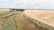 Cyclists cycling on gravel road in field. Adventure cycling concept. People enjoying sunny day, riding bicycles on rural gravel cy