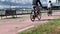 Cyclists rides along the bike path on the waterfront