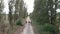 Cyclists riding on gravel bicycles on cobblestone road in countryside. Gravel bike adventures. Cycling on gravel road offroad. Peo