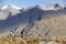 Cyclists Riding Past Mountains