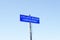 Cyclists riding road highway lane warning sign post blue sky background information