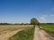 Cyclists in spring or summer dirt path