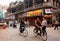 Cyclists on the vintage bircycles rush through the busy asian street