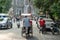 Cyclo pedicab on Hanoi street at early morning with St. Joseph Cathedral on background