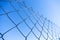 cyclone fence detail with blue sky