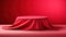 Cylinder podium covered with cloth on a red background.