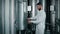 cylindrical-conical fermentation tanks with beer in modern brewery, man is taking sample