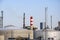 Cylindrical oil storage tanks. Industrial Zone. Towers and pipes against the blue sky