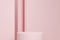 Cylindrical podium on a pink wall background. 3d rendering