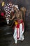 A Cymbal Player (Thalampotakaruwo) performs along the streets of Kandy during the Esala Perahera in Sri Lanka.