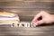 Cynic. Wooden letters on the office desk