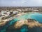 Cyprus beautiful coastline, Mediterranean sea of turquoise color. Houses on the Mediterranean coast. Tourist town. Nissi Beach.