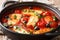Cyprus food baked Halloumi with tomatoes, peppers, olives in a spicy sauce close-up in a pan. horizontal