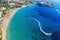 Cyprus landscape. Aerial panoramic view of Coral bay beach with jet ski and people having fun. Mediterranean vacation