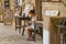 CYPRUS, NICOSIA - JUNE 10, 2019: Portrait of a young female crochet knitter sitting and and working in a local art gallery