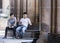 CYPRUS, NICOSIA - JUNE 10, 2019: Two men sitting and talking together on a bench next to ancient columns of the historic building