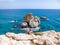 Cyprus - Young man sitting at a steep cliff with a sea view