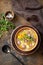 Czech food: Traditional Zelnacka cabbage soup with sausages and vegetables in a bowl on rustic wooden table. Top view flat lay