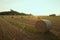 Czech middle age castle Kuneticka Hora with bales of hay and sunset - harvest at the end of summer (Pardubice)