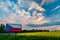 Czech republic flag highway billboard by road beside rapeseed field with sunset light and beautiful clouds