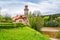 Czech republic, Talsperre Les Kralovstvi Forest Kingdom - May 15, 2021. Historic hydraulic water dam with orange water in river