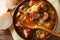 Czech traditional soup zelnacka of sauerkraut with sausages close-up in a bowl. Horizontal top view