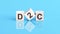 D2c - short for Direct-to-Consumer - word is made of wooden building blocks lying on the blue table