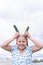 At the dacha, a girl holds fresh green cucumbers in her hands.