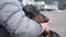 dachshund enjoys the warm summer sun, sitting on the owner's arms at the beach