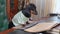 Dachshund student reads music sheets near paper keyboard