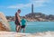 Dad care Son near sea, walk spend time together explore new. Man hold kid hand. Lighthouse background Symbol of