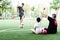 Dad coaches his children how to play soccer