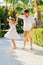 a dad and daughter dance on in a tropical park. attitude of fathers and children