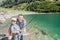 A Dad and daughter fishing together a trout in a mountain lake